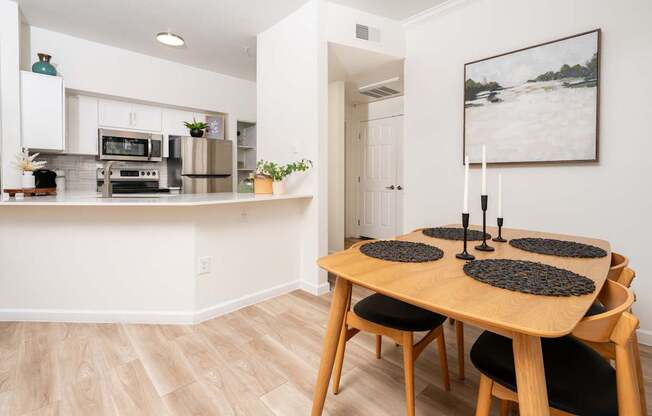A dining room with a wooden table and chairs.