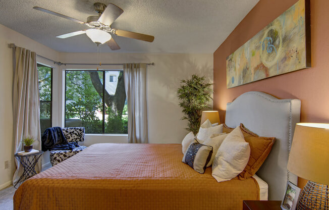 a bedroom with a large bed and a ceiling fan