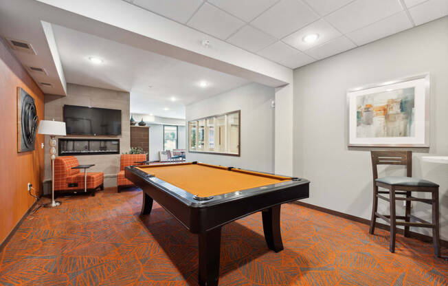 a games room with a pool table and a tv