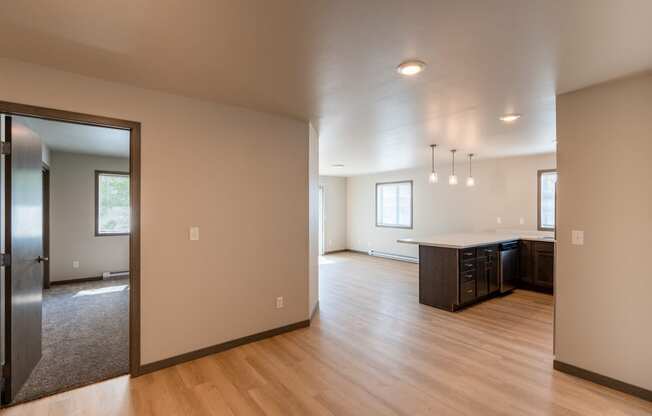 An open living room and kitchen and wood floors. Fargo, ND Granger Court Apartments.