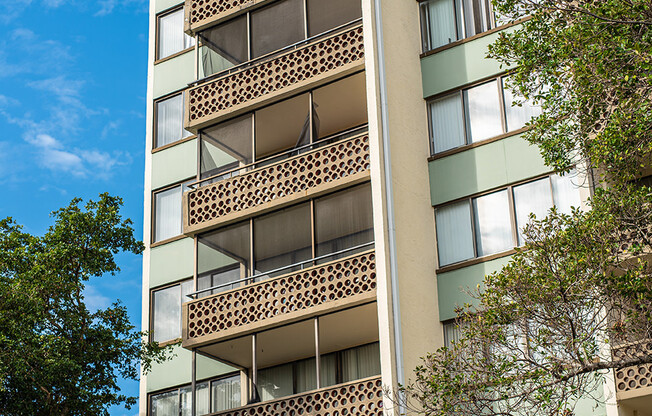 an apartment building with balconies and a blue sky at Fairways of Inverrary, Florida, 33319