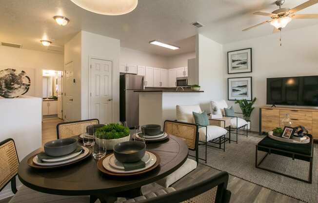 an open living room and dining room with a table and chairs