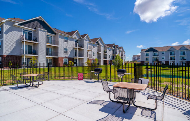 A sunny day at a grilling stations with seating area at The Reserve at Destination Pointe, Grimes, Iowa