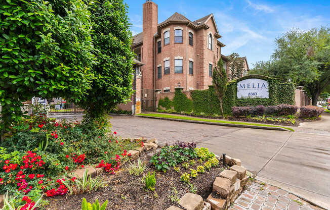 A brick building with a sign that says "MELIA" in front of it.