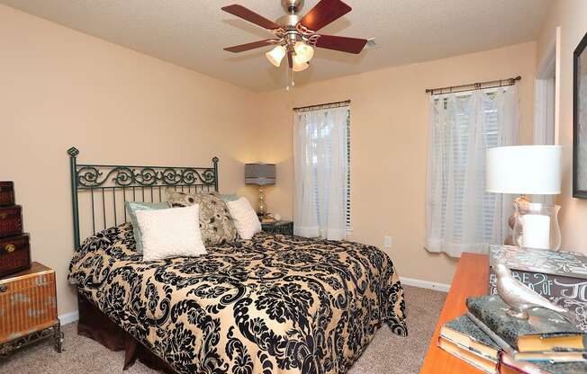 a bedroom with a large bed and a ceiling fan