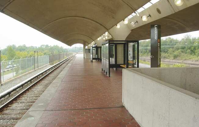 a train station with a train on the tracks