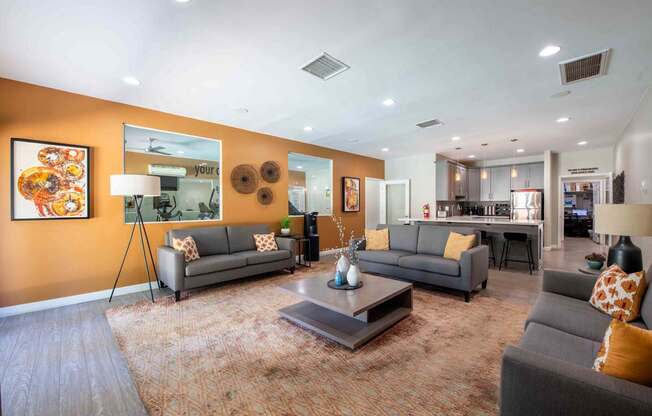 A living room with a grey couch and a coffee table.