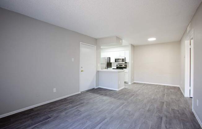 A room with a grey floor and a white wall.