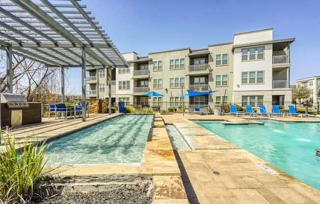 A large swimming pool with a walkway in between two pools.