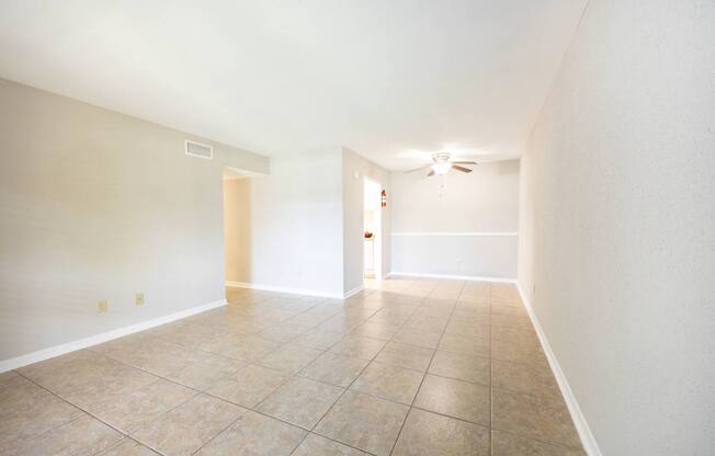 A room with a tiled floor and a ceiling fan.