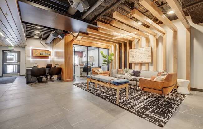 a lobby with couches and chairs and a rug