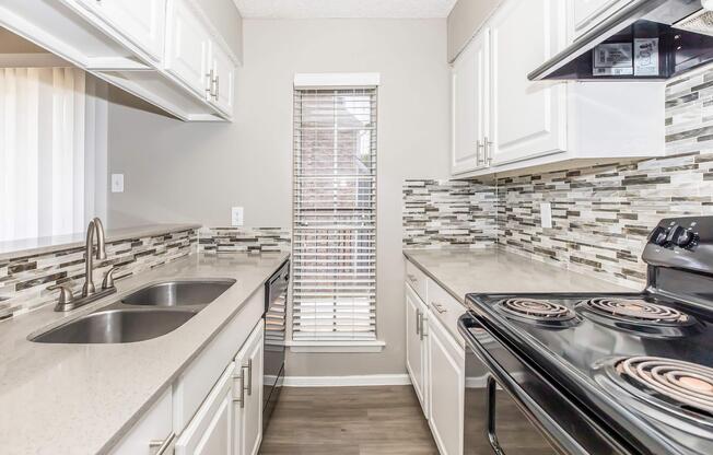 a kitchen with a sink and a refrigerator