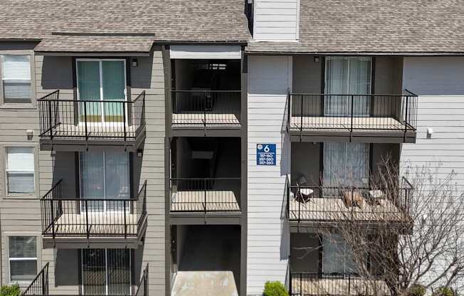 An apartment building with private balconies at The Park on Preston Apartments in Dallas, TX