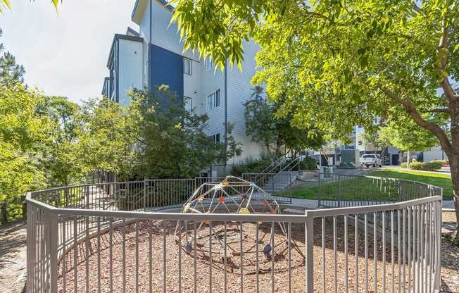 the preserve at ballantyne commons playground in front of a blue building with trees