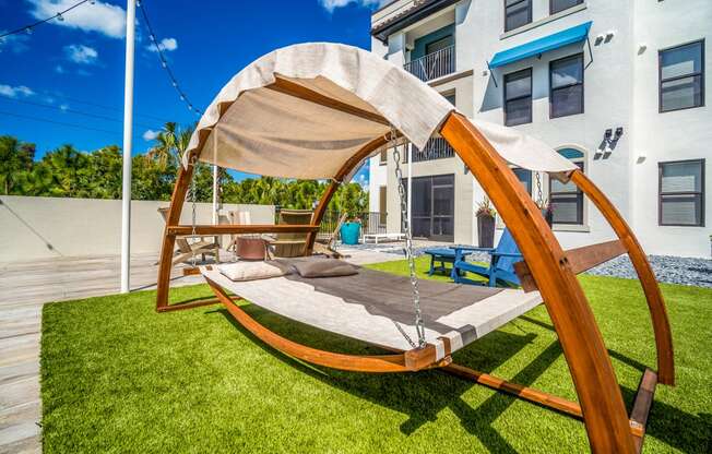 lawn with white and brown hanging chair at Magnolia Square, Naples, FL, 34109