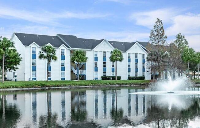 a building with a fountain in front of a lake