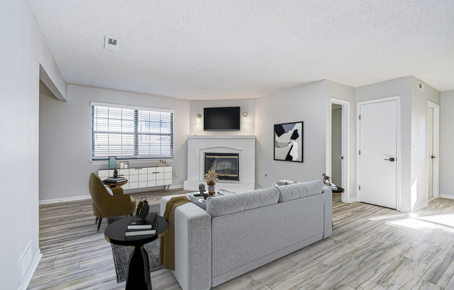 Furnished platinum living room interior with wall-mounted TV at The Arbor in Blue Springs, Missouri