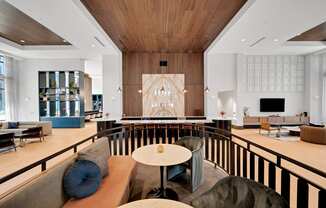 the lobby of a hotel with chairs and tables at Preston Ridge, Cary, 27513