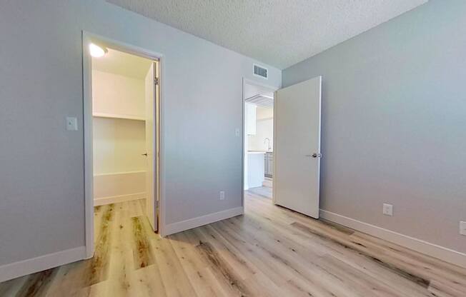 A room with a white door and a white wall.