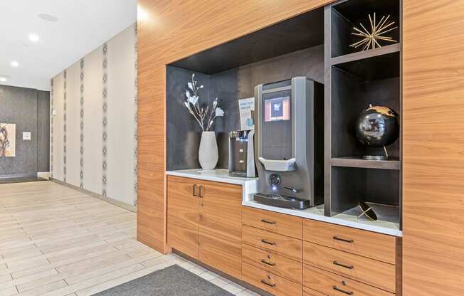a lobby with a wood paneled wall with a coffee machine
