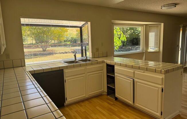 Lots of Square Footage in this wonderful 4 Bedroom (+ Bonus Room) 2.5 Bath Home...Beautiful Park Like Backyard.