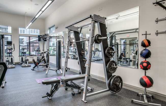 a fitness room with weights and other exercise equipment