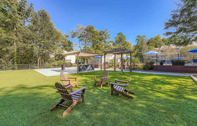 A backyard with a wooden bench and a gazebo.