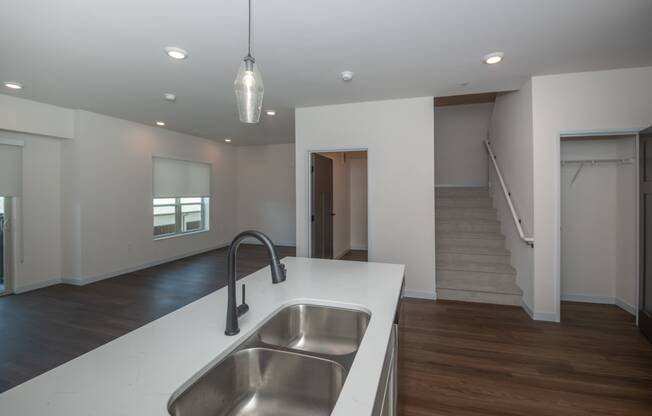 a white kitchen with a stainless steel sink and a white counter top at The Crossings at Windsong, Prescott Valley, Arizona
