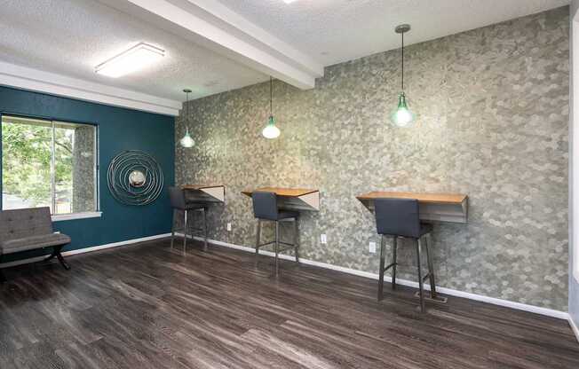 a community room with three tables and chairs and a window