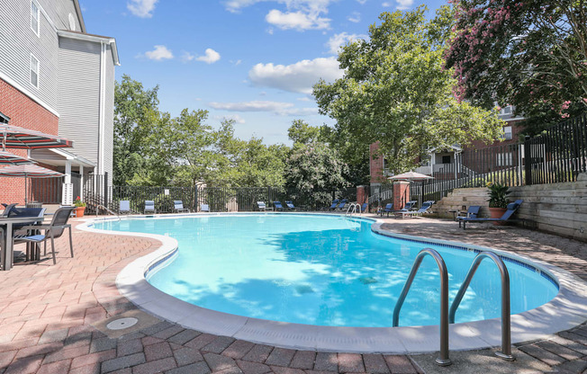 A small pool surrounded by a brick patio.