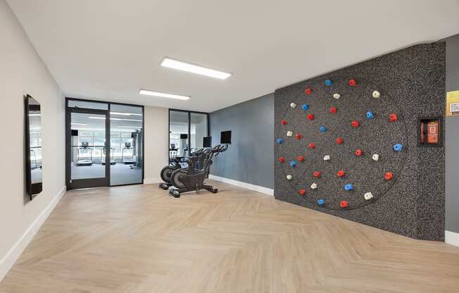 a rock climbing wall in a lobby with a chair at Copper and Quarry Village, Maryland, 21209
