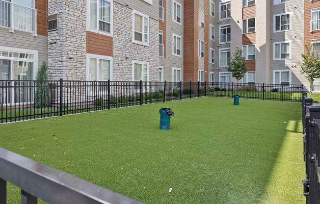a yard with a fire hydrant in front of an apartment building