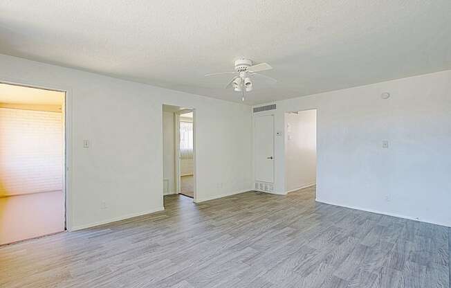 a bedroom with hardwood floors and white walls