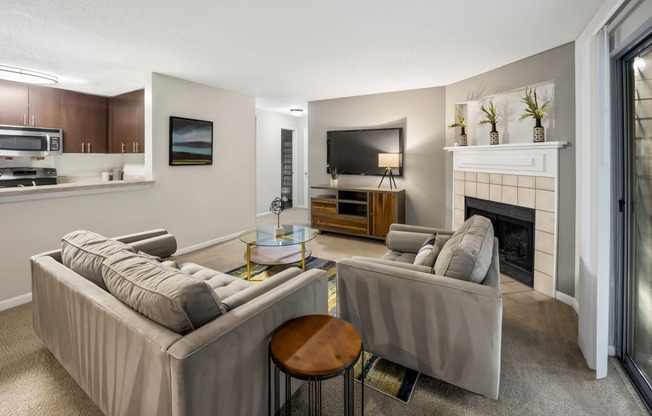 Living room with two couches and a fireplace at University Ridge Apartments, Durham, NC, 27707