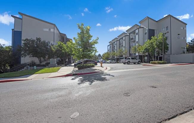 a view of a street with apartment buildings on the side of the road