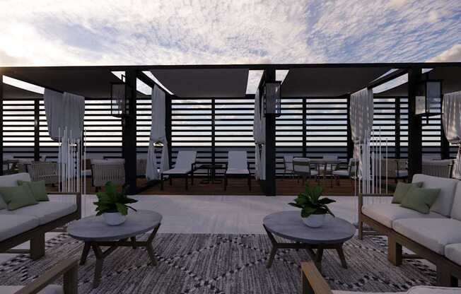 A modern outdoor living space with a wooden floor, white furniture, and a striped rug.