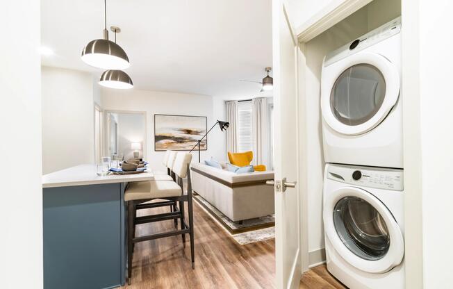 An in-home laundry setup with stacked washer and dryer, neatly tucked into a dedicated space that supports everyday living with ease.