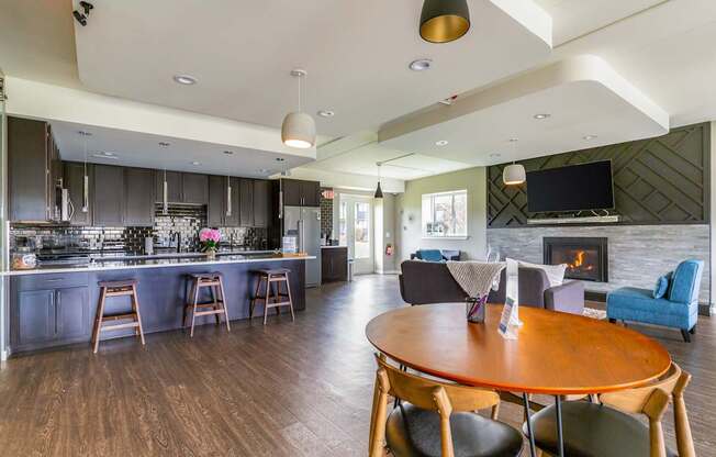 A modern kitchen with a wooden table and chairs.