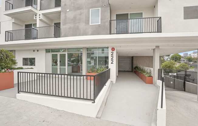 a building with a porch and a sign on the side of it