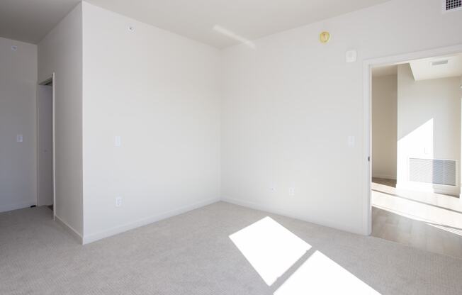 an empty living room with white walls and carpet at Riverhouse Apartments, North Dakota