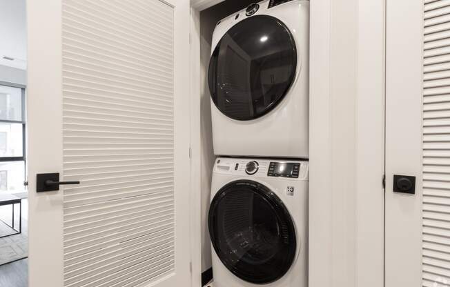 a front loading washer and dryer in a laundry room