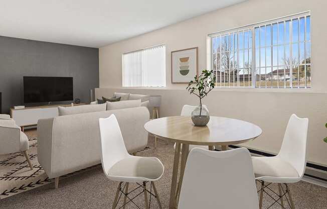 a living room with a table and chairs