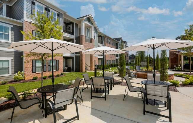 our apartments feature a patio with tables and chairs and umbrellas
