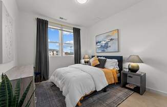 a bedroom with a bed and a window