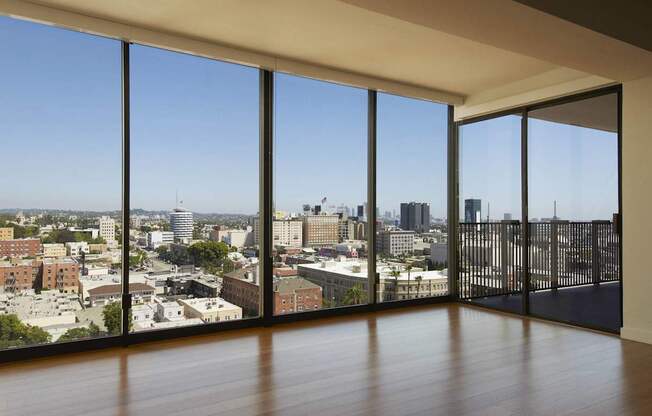 A room with a view of a cityscape through large windows.at Hollywood Ardmore, Los Angeles