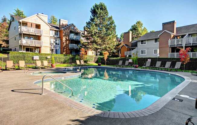 A swimming pool surrounded by a fence and buildings.