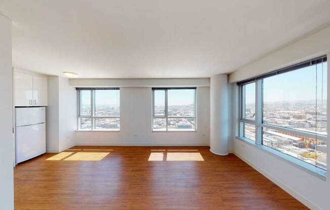 an empty living room with a view of the city