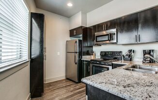 a kitchen with stainless steel appliances and granite counter tops
