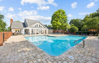 a swimming pool with a house in the background