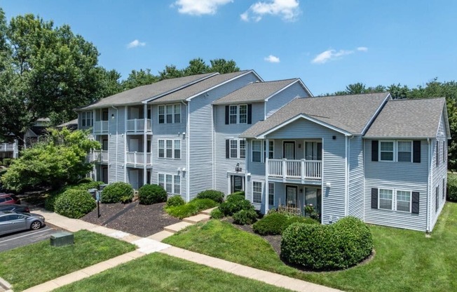 Apartment complex with multiple buildings and green lawns.